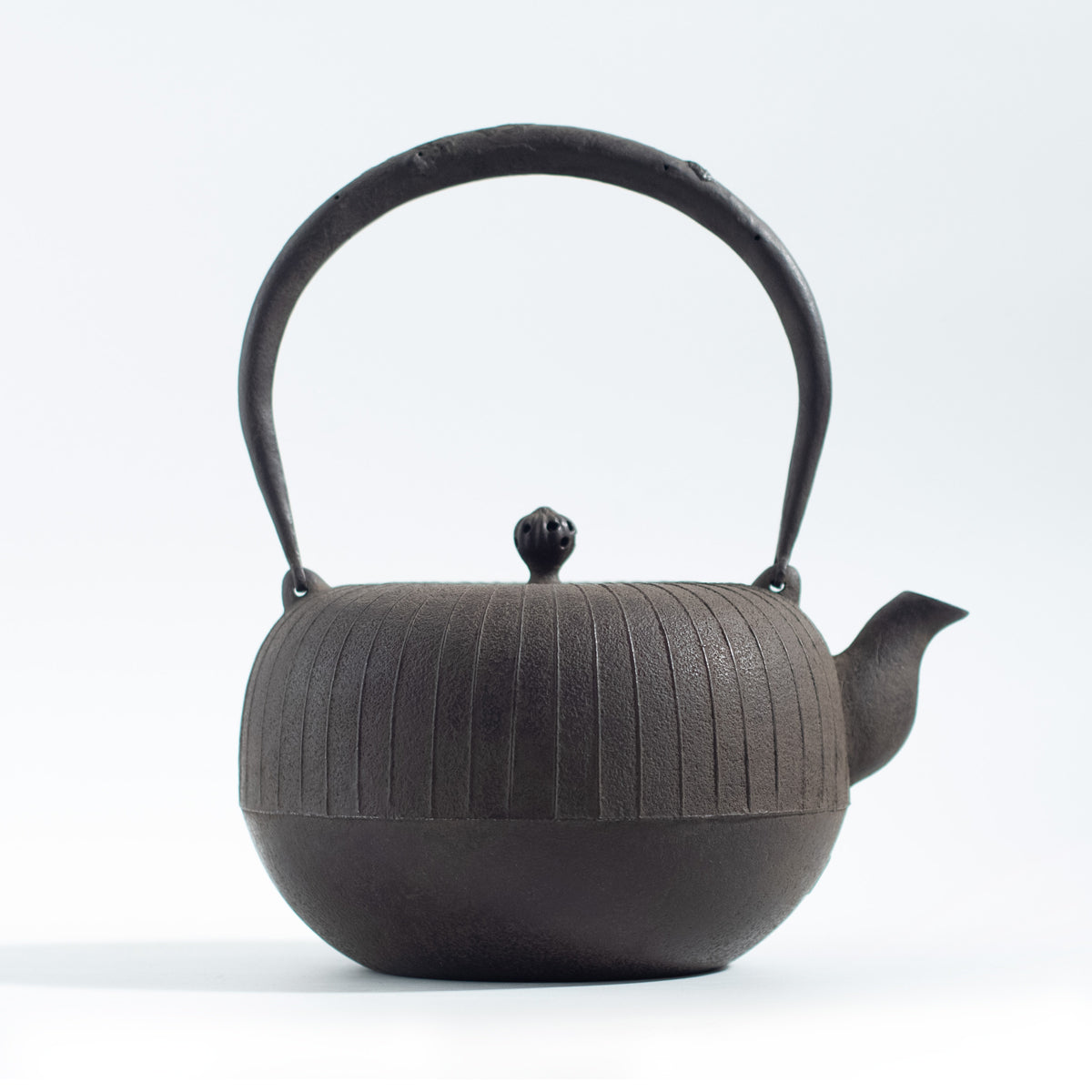 Iron Kettle with Vertical Stripe Pattern and Flat Circular Shape