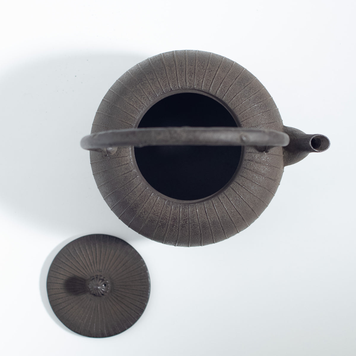 Iron Kettle with Vertical Stripe Pattern and Flat Circular Shape