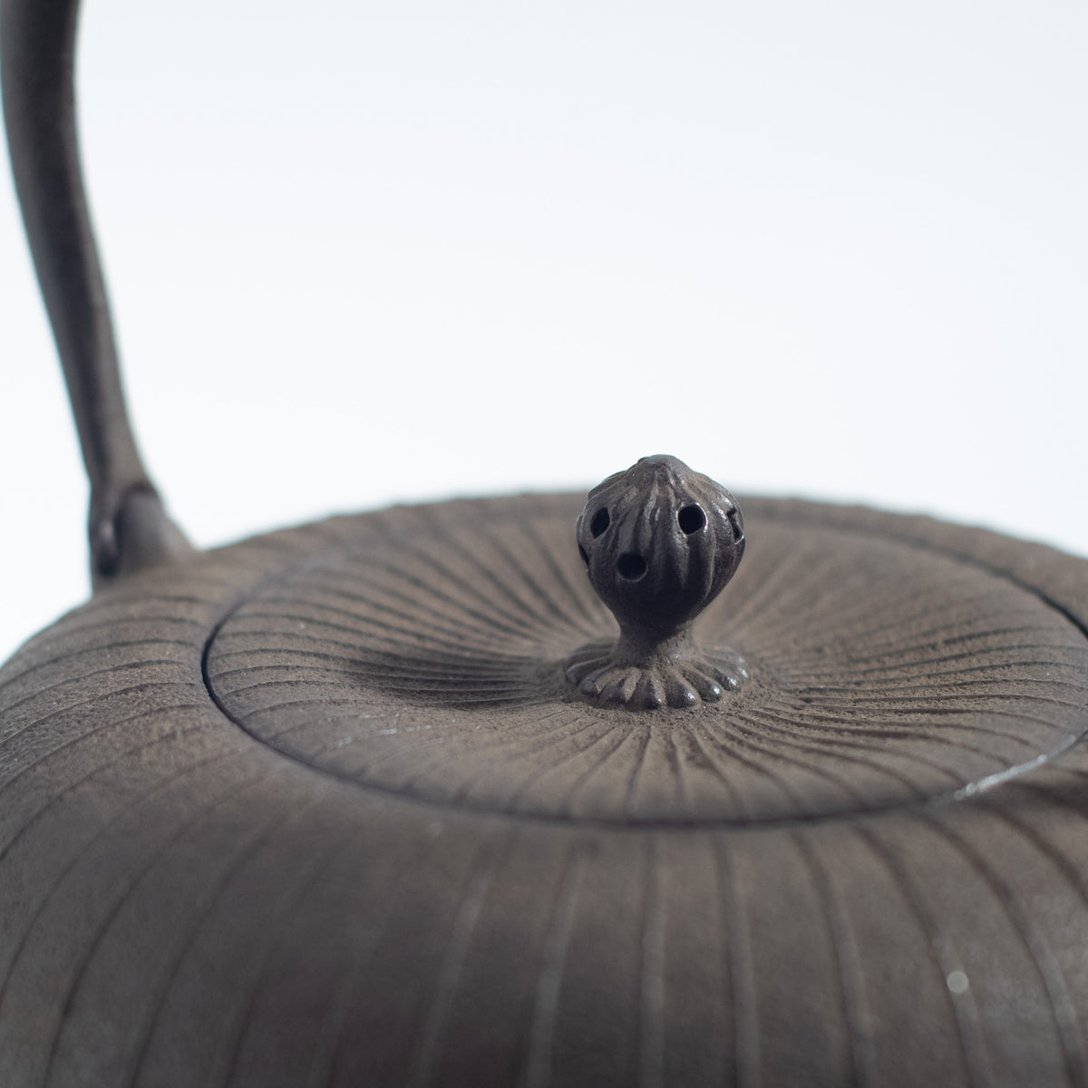 Iron Kettle with Vertical Stripe Pattern and Flat Circular Shape