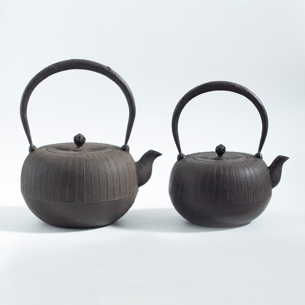 Iron Kettle with Vertical Stripe Pattern and Flat Circular Shape