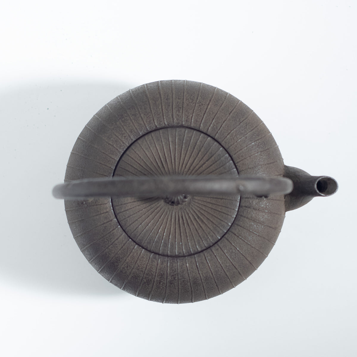 Iron Kettle with Vertical Stripe Pattern and Flat Circular Shape