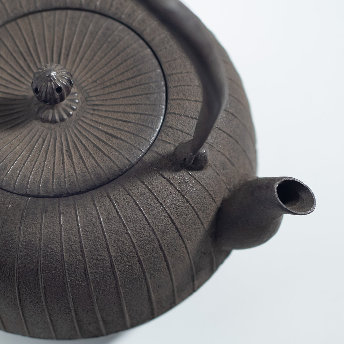 Iron Kettle with Vertical Stripe Pattern and Flat Circular Shape