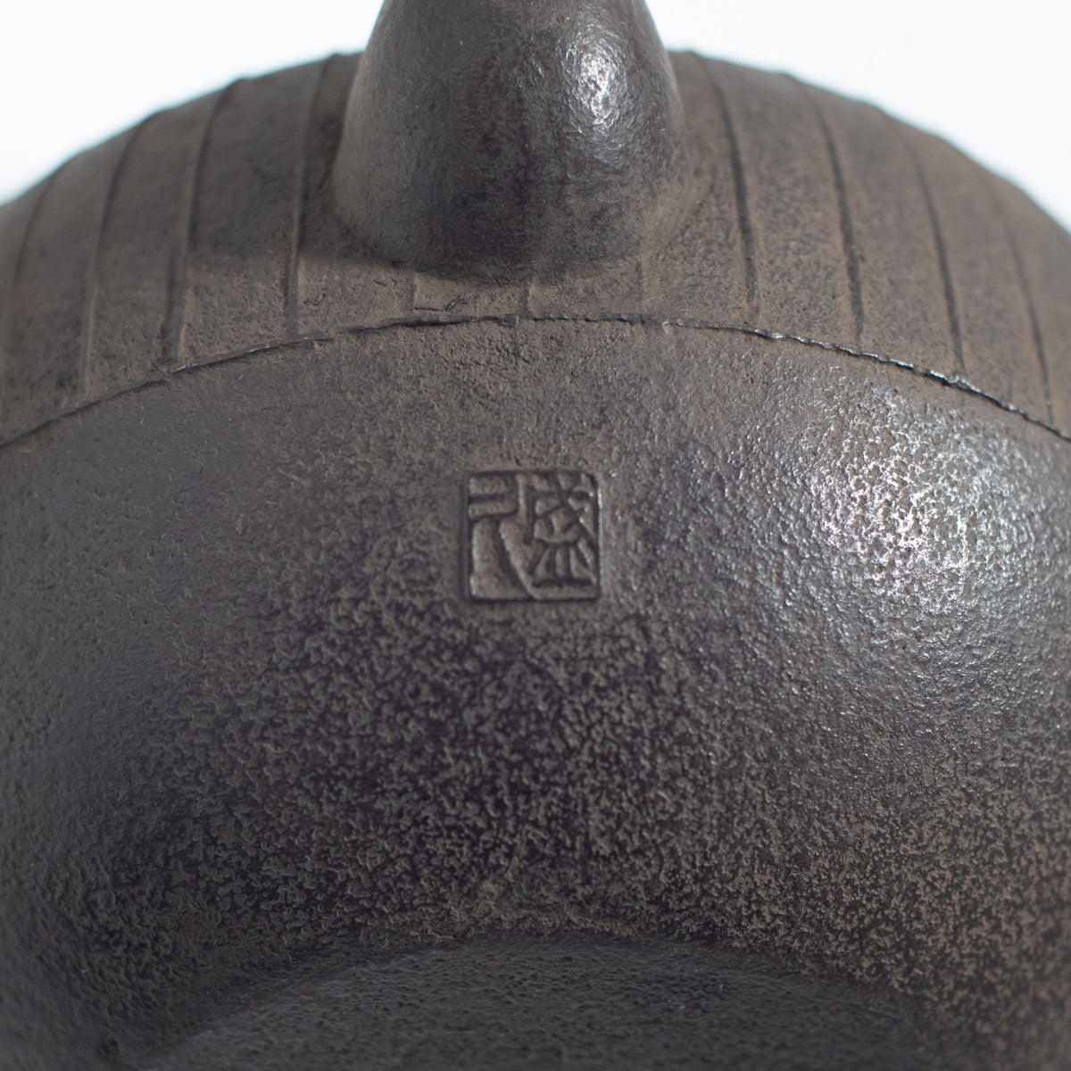 Iron Kettle with Vertical Stripe Pattern and Flat Circular Shape